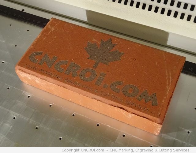 cnc laser engraving a red brick