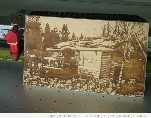 cnc laser engraving a wooden cottage on wood